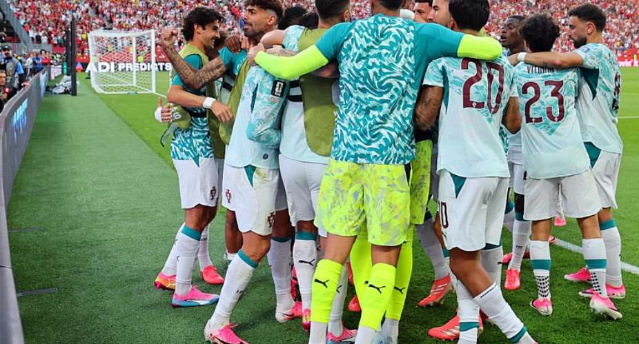 Portugals Cristiano Ronaldo celebrates scoring their first goal with teammates. -  Mike Segar, Reuters