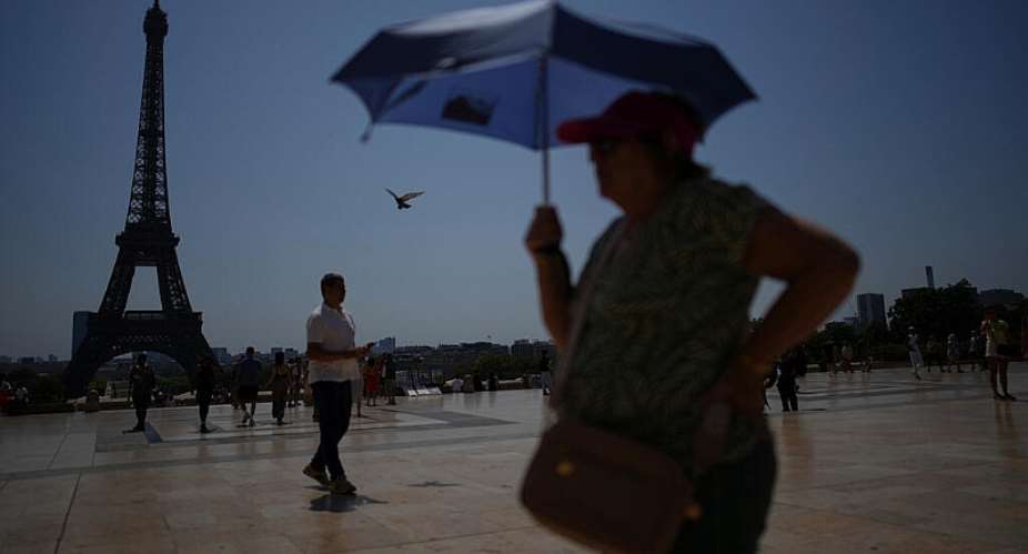 People brave the temperatures at the Trocadero plaza near the Eiffel Tower in Paris during a heat wave July 2, 2025. -  Christophe Ena, AP