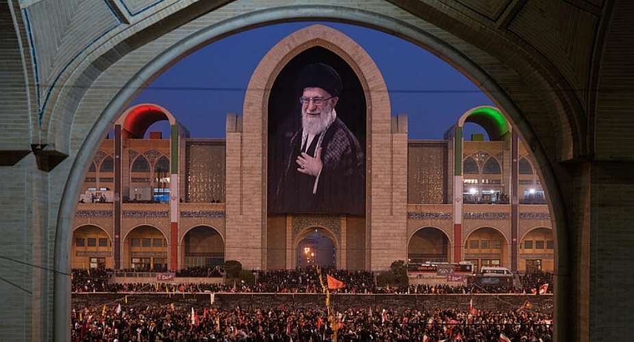 Mourners gather beneath a portrait of the late Iranian supreme leader Ayatollah Ali Khamenei during the funeral ceremonies for Khamenei and members of his family at the Imam Khomeini Mosalla Grand Mosque in Tehran, Iran, Saturday, July 4, 2026. -  Altaf Qadri, AP