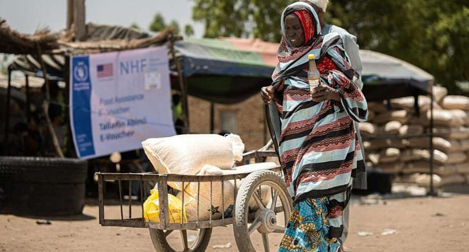 Yakura Usman, 70, walks after receiving food assistance at a distribution centre from where WFP provides relief, including in-kind food rations, electronic food vouchers, and specialized nutrition support for vulnerable households and internally displaced persons in Dikwa, Borno State, Nigeria, May 13, 2026. - via REUTERS - Khalid Hamza