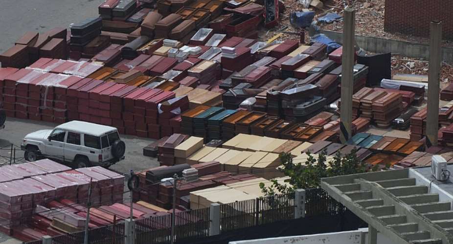 Coffins are stacked at the seaport where forensic workers sort the bodies of earthquake victims in La Guaira, Venezuela, Saturday, July 4, 2026. -  Ariana Cubillos, AP