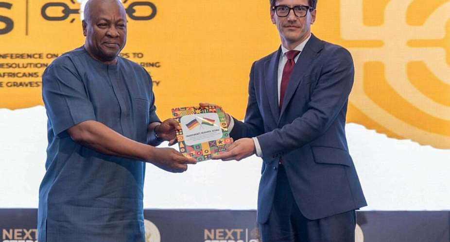 German Ambassador H.E. Frederik Landshft presenting a catalogue of artefacts to President John Dramani Mahama. -  Ghana Ministery of Foreign Affairs