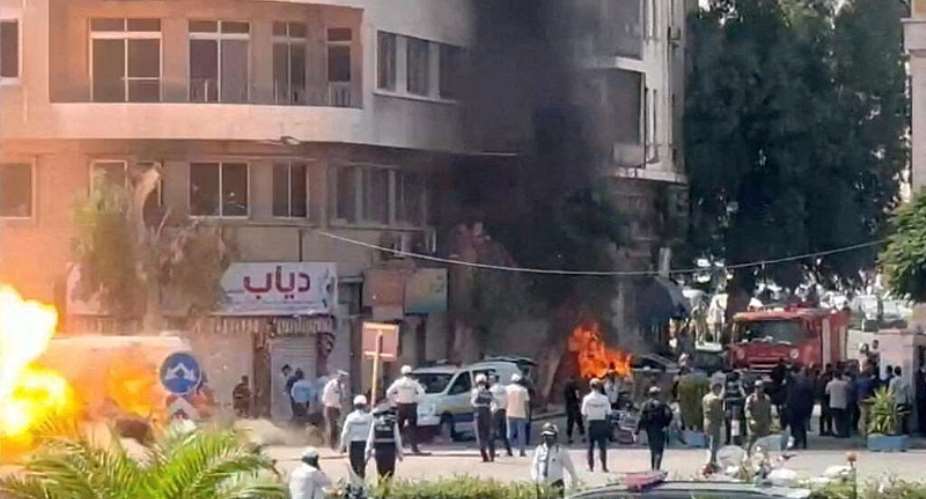 Emergency personnel work as smoke and fire rise at the site where explosive devices blew up near a hotel where French President Emmanuel Macron was meant to be staying, in Damascus, Syria, in this screengrab obtained from a video, July 7, 2026. -  
