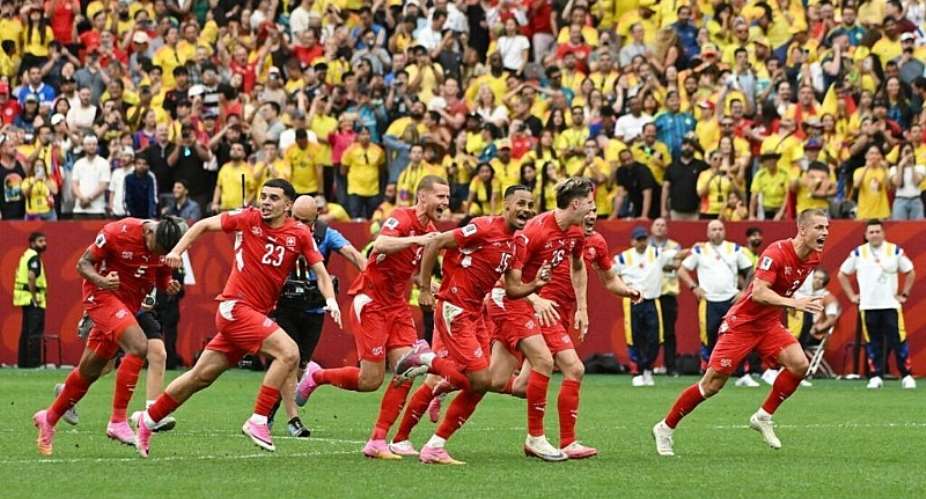 Switzerlands players race to celebrate after Ruben Vargas slots in the winning penalty against Colombia. -  Simon Fearn, Reuters