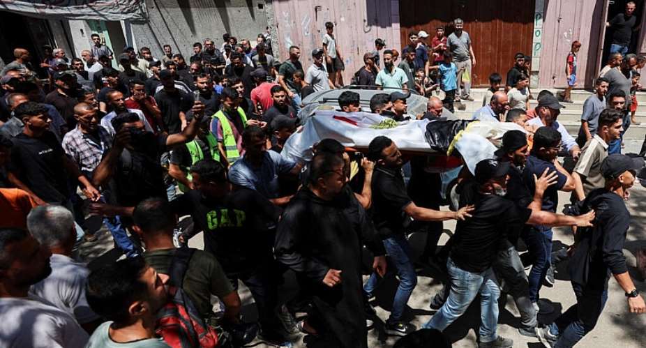 Mourners carry the body of Palestinian man Mohammad al-Waheidi, who worked for the Egyptian Relief Committee and was killed in an Israeli strike on Tuesday, during his funeral, in Gaza City, July 8, 2026. -  Dawoud Abu Alkas, Reuters