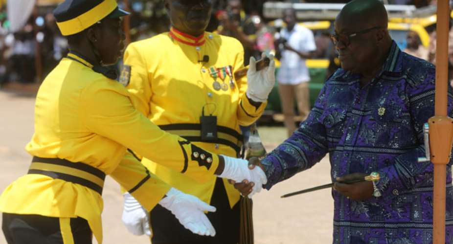 President Akufo-Addo presenting a Commandant Award to JUO Asomaning Mabel.