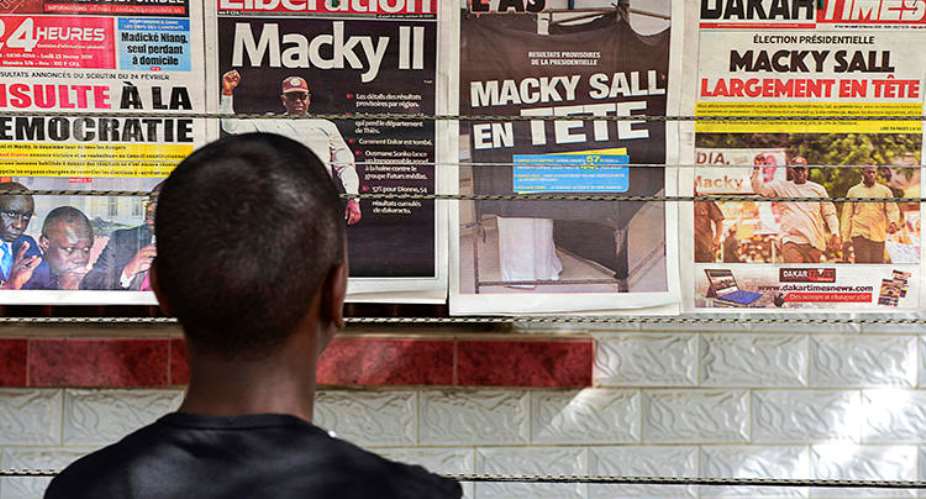 A man looks at newspaper front pages in Dakar, on February 25, 2019, one day after Senegal's presidential elections. Senegalese authorities arrested critical journalist Adama Gaye on July 29. AFPSeyllou