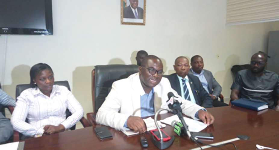 Sarfo Mensah with his team addressing the media yesterday at his office