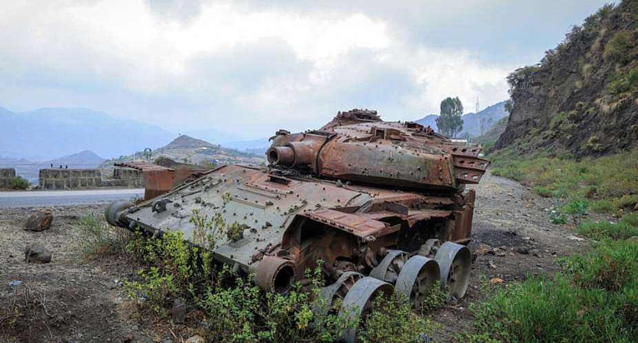 The remains of a tank from clashes between the Ethiopian National Defense Force and the Tigray Peoples Liberation Front on a road near Gereb Agew, Southern Tigray, Ethiopia, 3 March. - AFP - ABEL GEREZGIHER