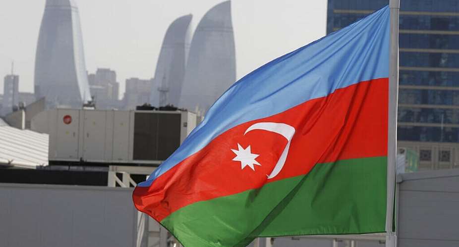 The Azerbaijan flag seen against the skyline of the capital Baku. - AP - Luca Bruno