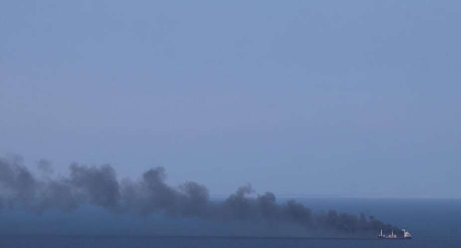 File photo: Smoke rises from civilian cargo ship Golden Leo following an alleged Russian missile strike on the Black Sea near Odesa on July 19, 2026. -  Stringer, AFP