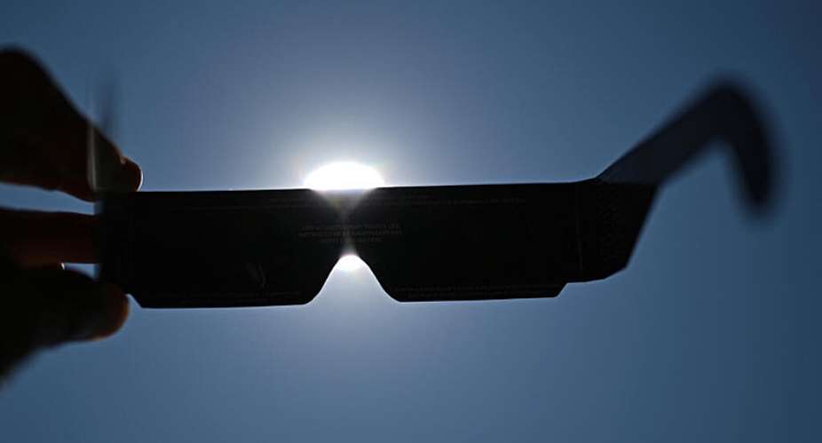 An observer tries eclipse-viewing glasses for direct observation of the sun in Beziers, southern France, on August 5, 2026, ahead of the August 12 solar eclipse. -  Gabriel Bouys, AFP