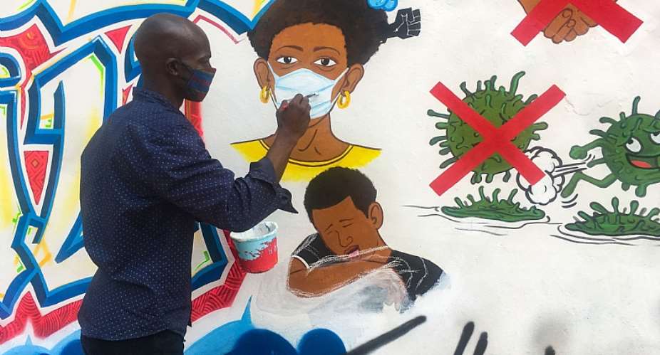 Congolese artist Chris Shongo paints on the outside wall of the Academie des Beaux-Arts in Kinshasa on June 18, 2020.  - Source: