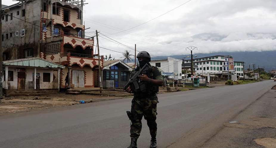 A Cameroonian elite Rapid Intervention Battalion member walks along an empty street in the city of Buea in Cameroon's Anglophone southwest region on October 4, 2018. Cameroon's military detained pidgin news anchor Samuel Wazizi on August 2, 2019, in Buea. ReutersZohra Bensemra