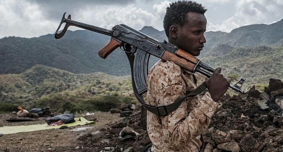 An Afar Special Forces member stands beside a damaged house near the village of Bisober in Ethiopias Tigray region. The village was damaged during fighting between Tigrayan and Ethiopian federal forces. - AFP - EDUARDO SOTERAS