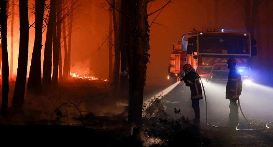 Firefighters work to put out flames burning in Luglon, France. -  Stephanie Lecocq, Reuters