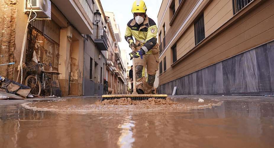 A firefighter sweeps away mud after floods in Paiporta, Spain on November 7, 2024. -  Alberto Saiz, AP