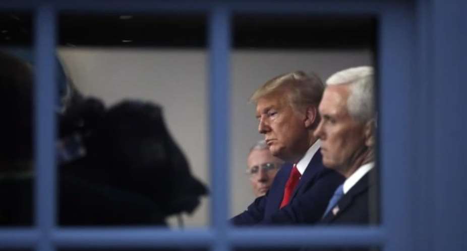President Donald Trump and Vice President Mike Pence listen to a briefing about the coronavirus at the White House in Washington, March 31, 2020 AP photo by Alex Brandon.