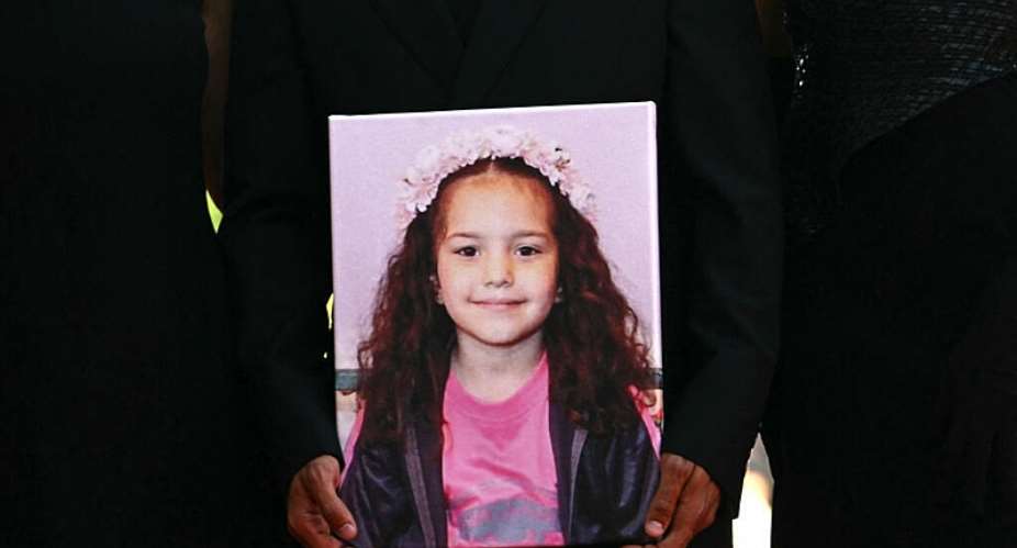 A person holds a photo of Hind Rajab, the 5-year-old Palestinian girl who was killed in January 2024, during a screening of The Voice of Hind Rajab on September 3, 2025. -  Stefano Rellandini, AFP
