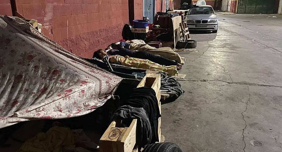 Migrants sleep in the Tarajal industrial zone in Ceuta on August 17, 2026. -  Hamza HABHOUB