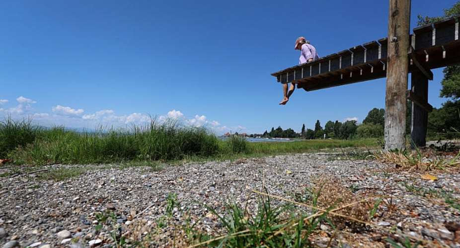 A woman lies on a jetty that ends at the dry shore of Lake Constance in Wasserburg, southern Germany, on July 2, 2026. -  Karl-Josef Hildenbrand, AFP