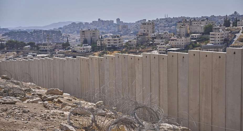 The separation wall next to the Arab neighbourhood of Al-Eizariya, near where the Israeli government says housing units will be built as part of the its E1 settler project, pictured on Thursday, August 21, 2025. -  Ohad Zwigenberg, AP