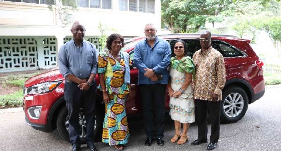 Former President Rawlings and his associates pose with Madam Pomary.