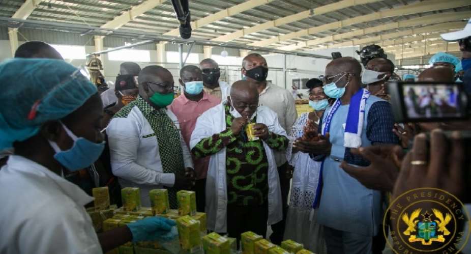 President Nana Akufo-Addo drinking Eku juice at the factory during opening ceremony