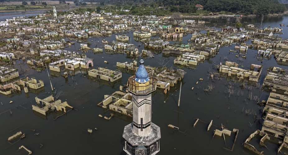 An aerial view taken on July 30, 2026 shows a mosque and surrounding buildings in Somang village in Lebak in Indonesias western Banten province, which was deliberately flooded to make way for the construction and filling of the Karian Dam that opened in 2023 and has now re-emerged due to the El Nino-driven drought. Indonesia believes cloud seeding can help it tackle a wildfire season that experts say is on track to be among the worst in years, driven by a strong El Nino. -  Bay Ismoyo, AFP