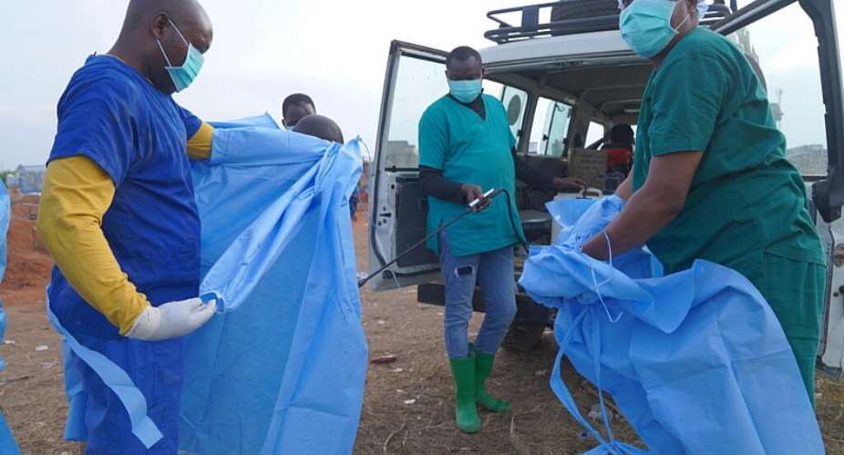 A health worker sprays a colleague with disinfectant after taking part in a burial service for 3-year-old Mave Mercienne, who died of Ebola, in Bunia, Ituri province, eastern Congo on August 18, 2026. -  Dieudonne Dirole, AP