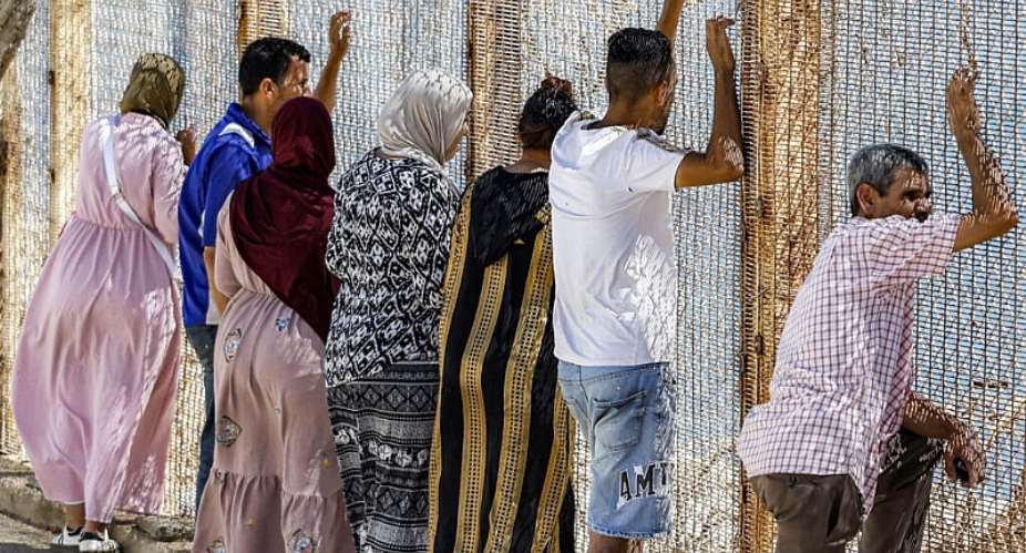 Families watch as migrants return after crossing the border into the Spanish enclave of Ceuta, at the Bab Ceuta border post near the town of Fnideq, Morocco on August 2, 2026. -  Abdel Majid Bziouat, AFP