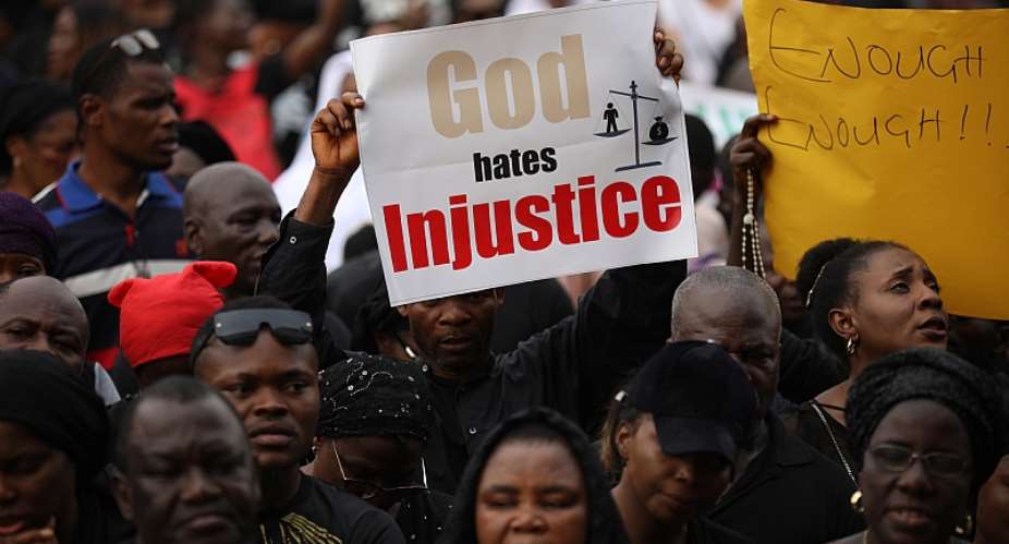 Christians hold signs as they march on the streets of Abuja calling for peace and security in Nigeria. - Source: Photo by Kola SulaimonAFP via Getty Images