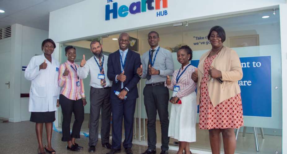 Dr. Elikem Tamaklo in front of the health hub with staff of Nyaho Medical Centre