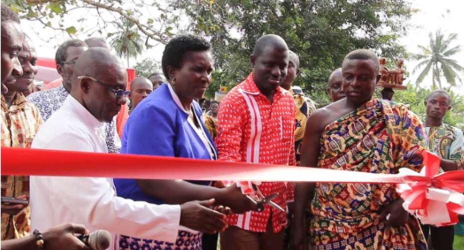 Mrs. Macaiver Ivy Quaye, District Director of Education 2nd from left being assisted by Samuel Gyimah 2nd from right, National Distribution Manager-Airtel Ghana and Nana Krampah Kwame Saisi VIII to cut the tape to officially commission