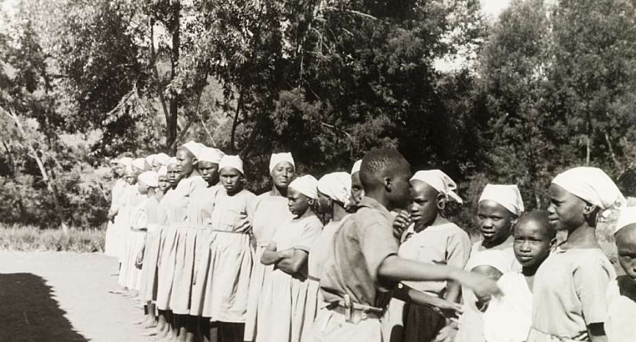 Young Kikuyu women lined up outdoors at a Church of Scotland mission school in Kenya. - Source: Bristol Archives/Universal Images Group/Getty Images