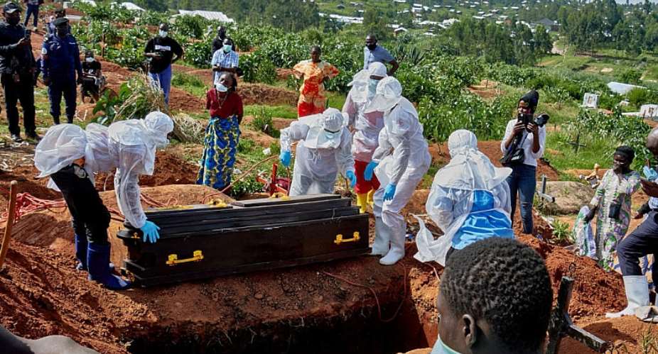 Red Cross workers wearing personal protective equipment prepare to lower a coffin of a doctor who died of the Ebola virus, at the Nyamurongo cemetery in Bunia, Ituri province, DRC 26 May 2026. -  Gradel Muyisa Mumbere/Reuters