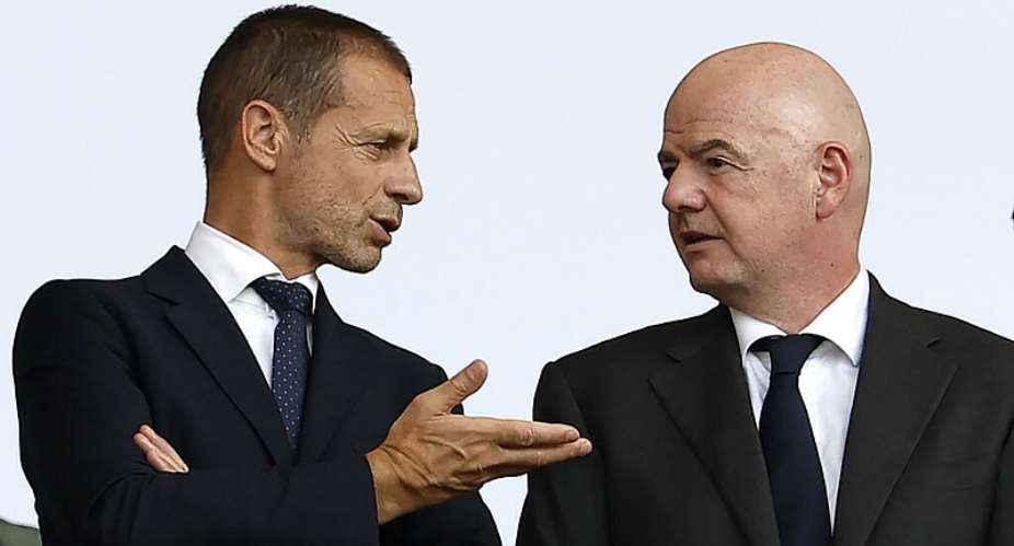 File - UEFA president Aleksander Ceferin speaks with Fifa president Gianni Infantino before the start of the UEFA Euro 2024 round of 16 football match between Switzerland and Italy at the Olympiastadion Berlin in Berlin on June 29, 2024. -  Odd Andersen, AFP