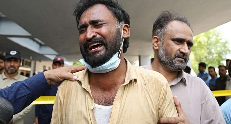 A man in tears outside the PIMS maternity ward, where a fire killed more than a dozen infants. -  Aamir Qureshi, AFP