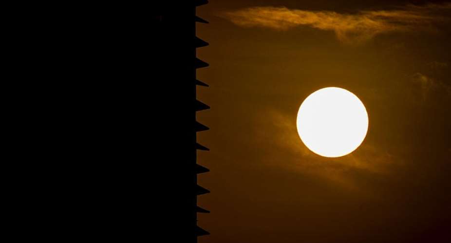 The sun is pictured next to the silhouette of a building during sunset in Panama City on April 9, 2026 -  Martin Bernetti, AFP