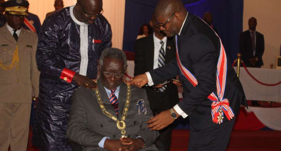 President George Manneh Weah decorating John Agyekum Kufuor
