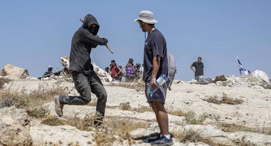 An Israeli settler attacks a left-wing activist at an Israeli outpost in the Israeli-occupied Palestinian village of Jannatah, just south of the city of Bethlehem on August 25, 2026. -  Ilia Yefimovich, AFP