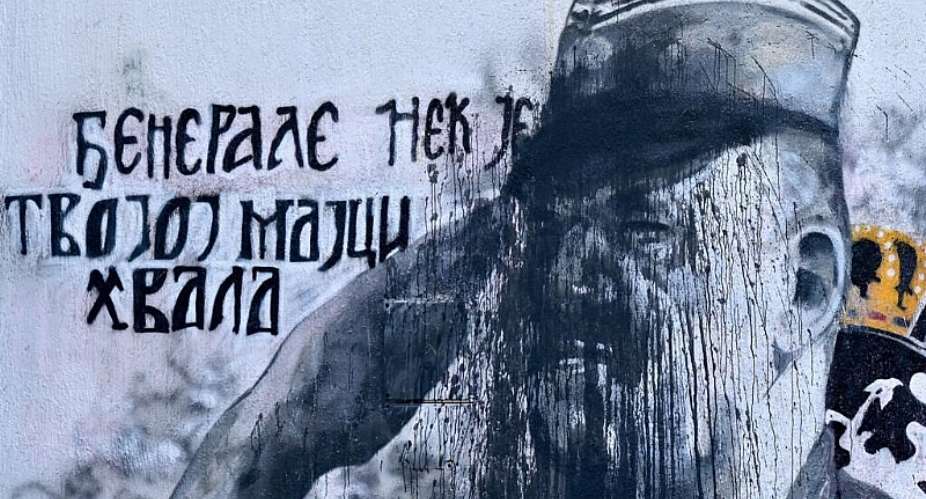 A picture taken in Belgrade on November 15, 2021 shows a mural, vandalized with black paint, depicting former Bosnian Serb military chief Ratko Mladic. -  Andrej Isakovic, AFP
