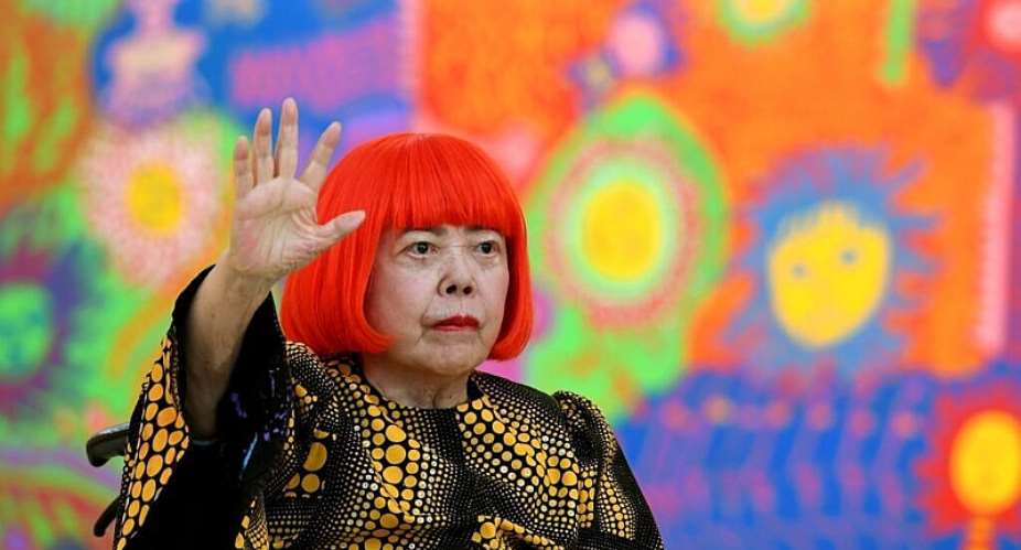 File - Japanese artist Yayoi Kusama waves at a photo session during a press preview of her exhibition titled My Eternal Soul at the National Art Center in Tokyo on February 21, 2017. -  Toshifumi Kitamura, AFP