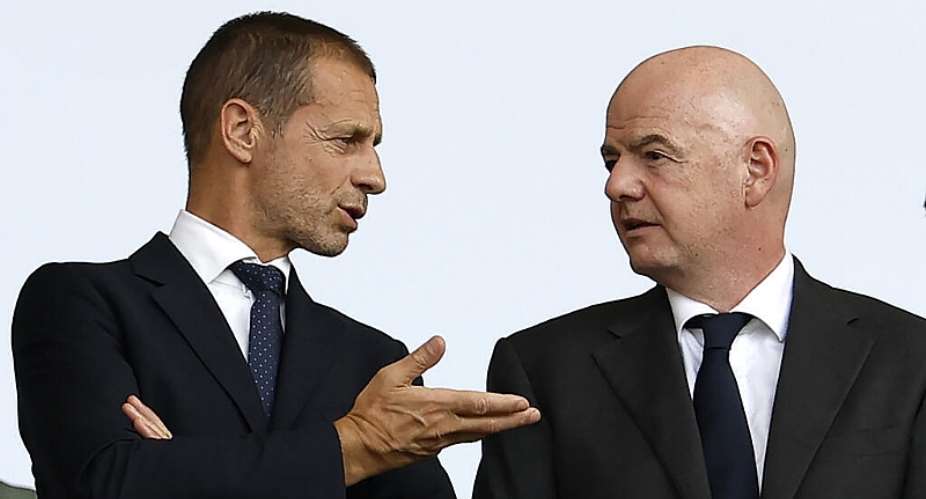 UEFA president Aleksander Ceferin speaks with FIFA president Gianni Infantino during a match at Euro 2024 in Berlin on June 29, 2024. -  Odd Andersen, AFP