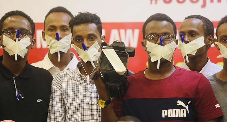 Journalists cover their mouths and cameras with tapes and pens to show protest their disapproval to the draconian media bill which was recently signed into a law. Photo credit: SJS