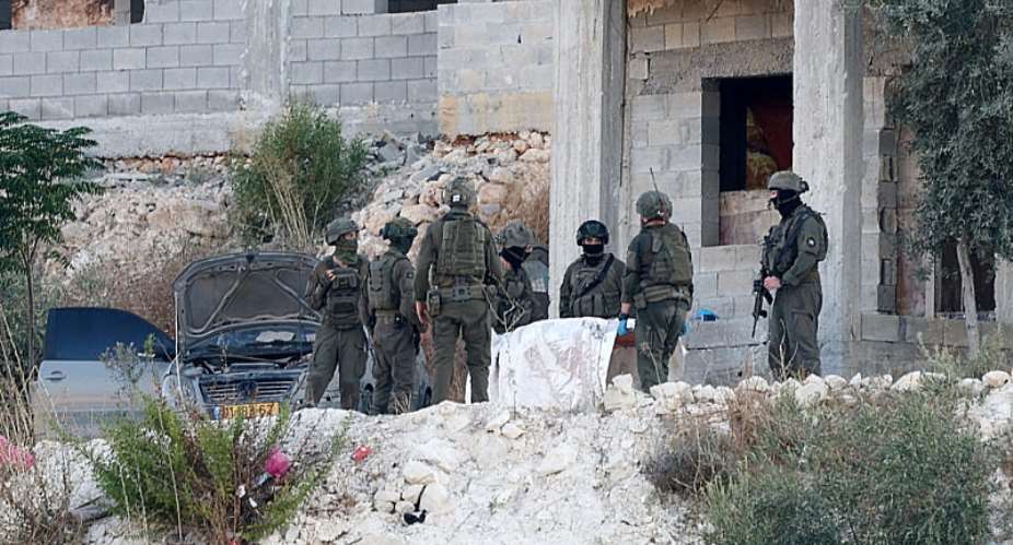 Israeli military forces carry the body of a Palestinian following the strike in Jenin, on August 28, 2026. -  Mohamad Torokman, Reuters