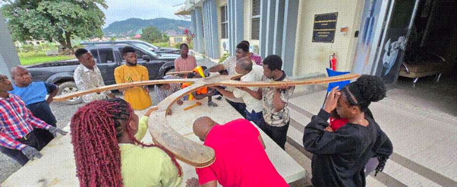 A group of students and researchers assembling a section of the TART.