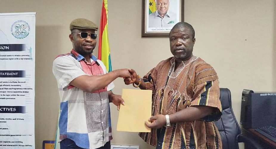 Executive Director of CFF-GHANA, Richard Kasu handing over the communique from the Volta Regional Water and Sanitation Dialogue to the Volta Regional Minister, Hon James Gunu