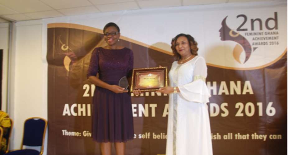 Ms. Akutu left, left being presented with her trophy and plaque by the Deputy Finance Minister, Mrs. Mona Quartey at the Feminine Ghana Achievement Awards