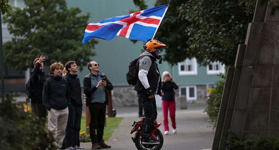 A man with an Icelandic flag rolls around in a park ahead of a referendum on whether Iceland should resume accession negotiations with the European Union, in Reykjavik, Iceland, on 29 August, 2026. - REUTERS - Leonhard Foeger
